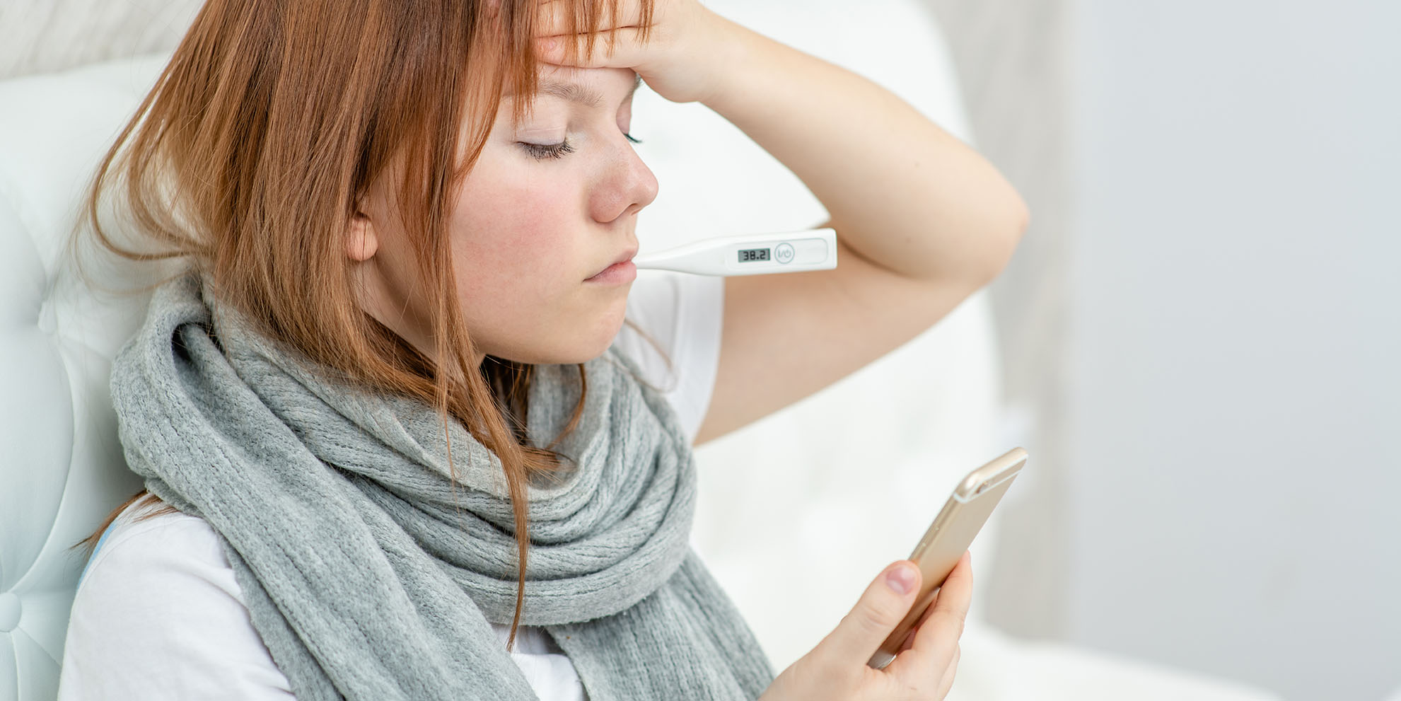 Teen girl using smartphone to talk to her doctor via video conference medical app